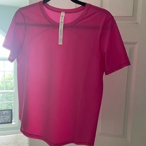 Pink Lululemon never worn short sleeve top. 91% Polyester and 9% Lycra Elastane